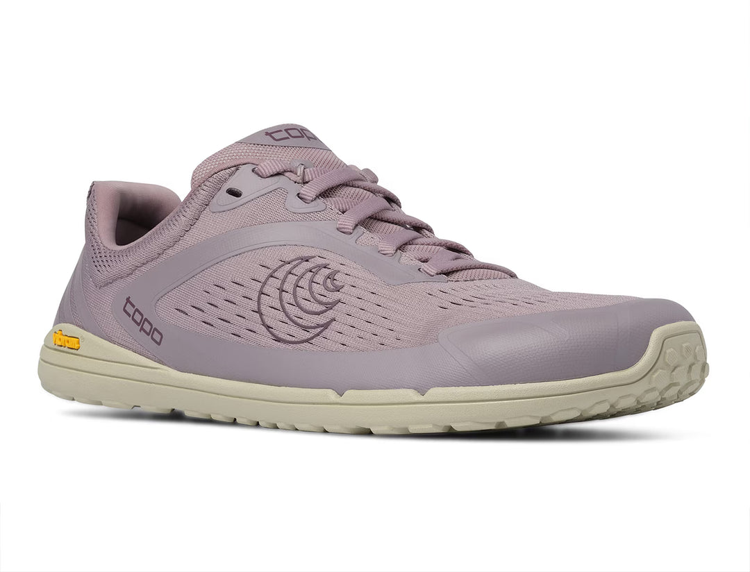A women’s Connect athletic shoe by TOPO, featuring a light purple mesh upper, beige sole, lace-up design, and TOPO branding on the side and tongue; it showcases a Vibram outsole for improved traction and durability and is displayed against a white background.