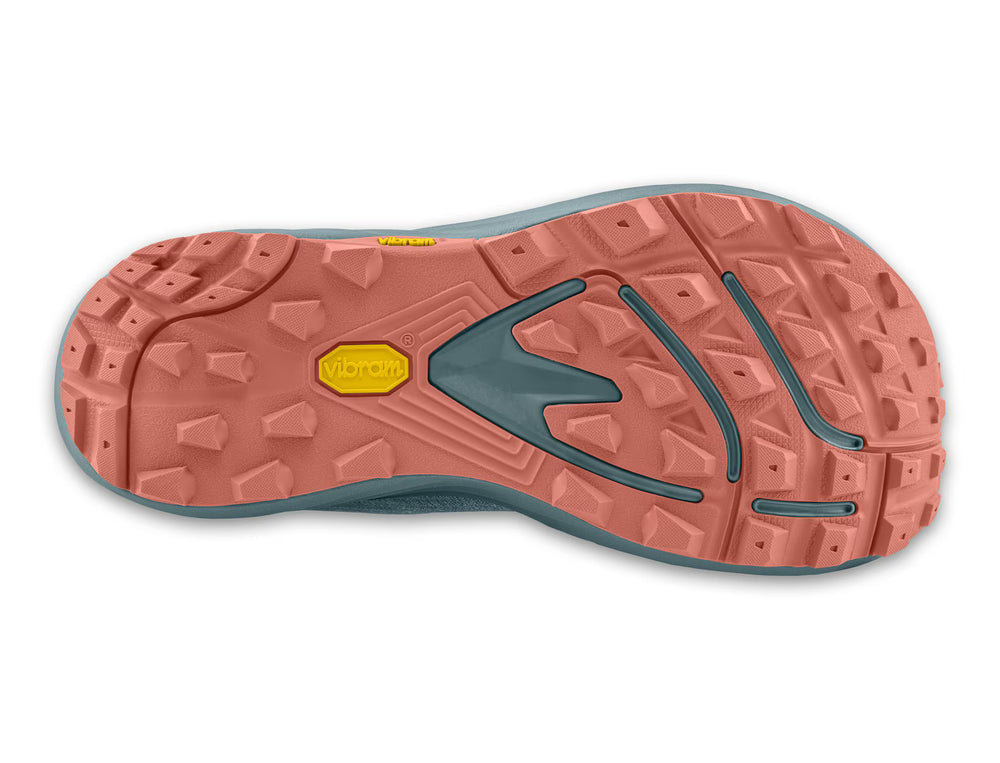 The underside of a TOPO Pursuit 3 (Women’s) zero drop trail runner, featuring a multi-directional lugged Vibram Megagrip outsole in coral and slate gray with two yellow Vibram brand logos.