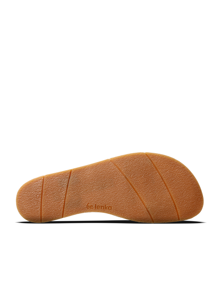 The image shows the sole of the BeLenka Promenade 2.0 (Women's) sandal, featuring textured light brown rubber with three diagonal grooves and the BeLenka brand name imprinted near the center.