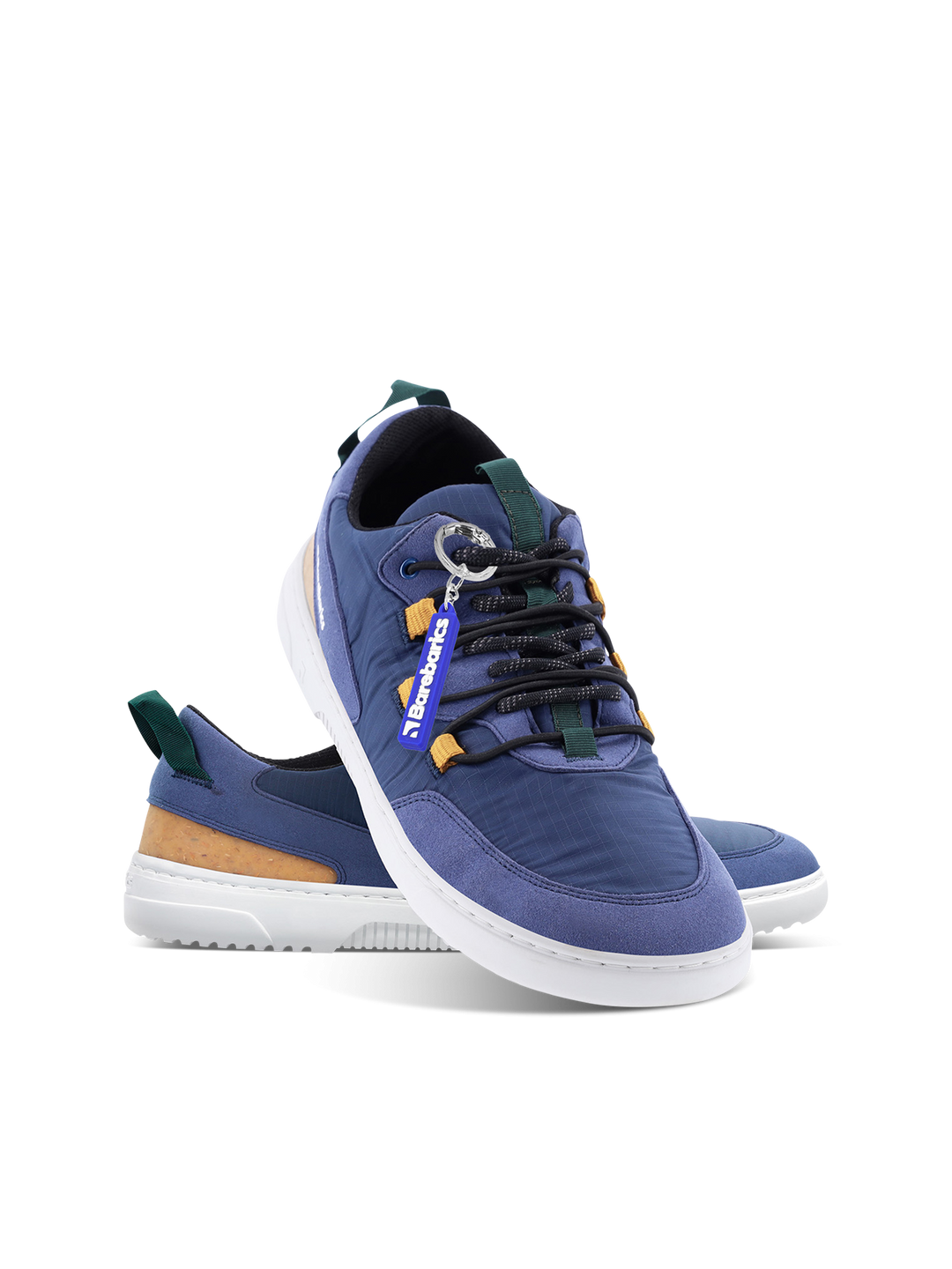 The Barebarics Revive (Men's) is a pair of blue casual sneakers with white soles, dark blue laces, green and tan accents, made from vegan materials for barefoot comfort and lightness, featuring a detachable blue DARKWOOD tag on a plain white background.