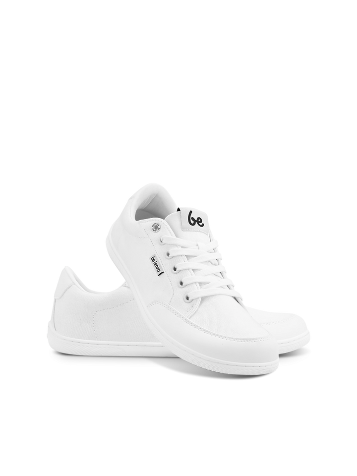 A pair of white BeLenka Rebound (Unisex) canvas retro sneakers with white laces. One shoe stands upright, the other leans beside it. Both feature a side label and a black logo on the tongue, set against a plain white background.