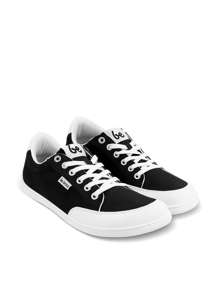 The BeLenka Rebound (Unisex) sneakers are black and white with white laces and soles, a small branded tag on the side, and a logo on the tongue. They are comfortable and shown on a plain white background.