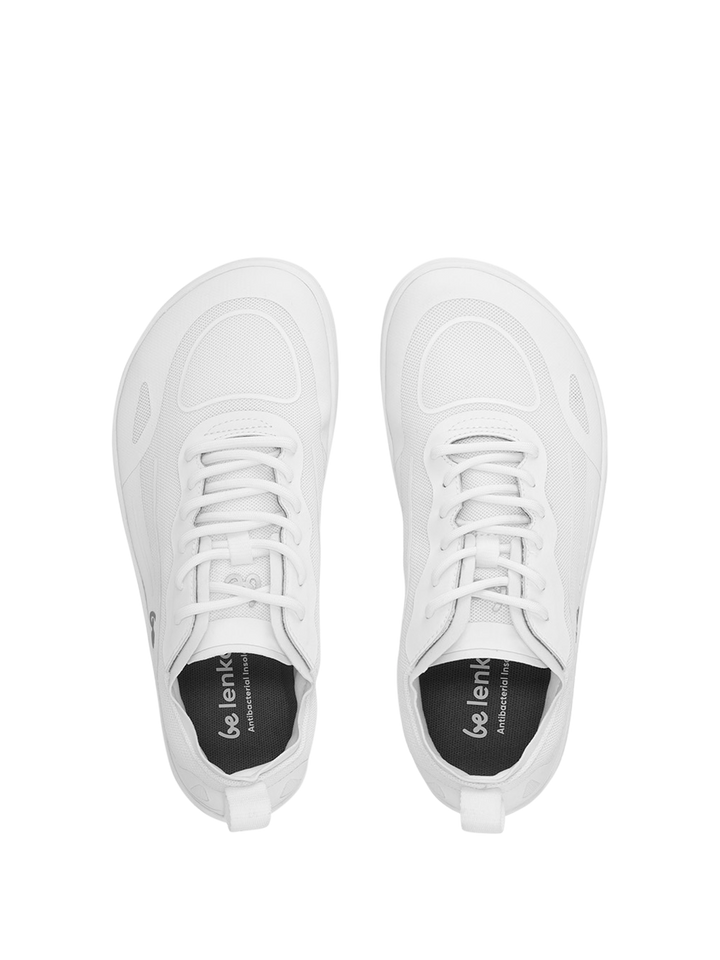 Top view of a pair of white Velocity (Unisex) athletic shoes with laces and black insoles. Positioned side by side on a white background, the insoles display the BeLenka brand name. These zero-drop trainers feature a flexible sole, delivering exceptional comfort and promoting natural movement during your workouts.