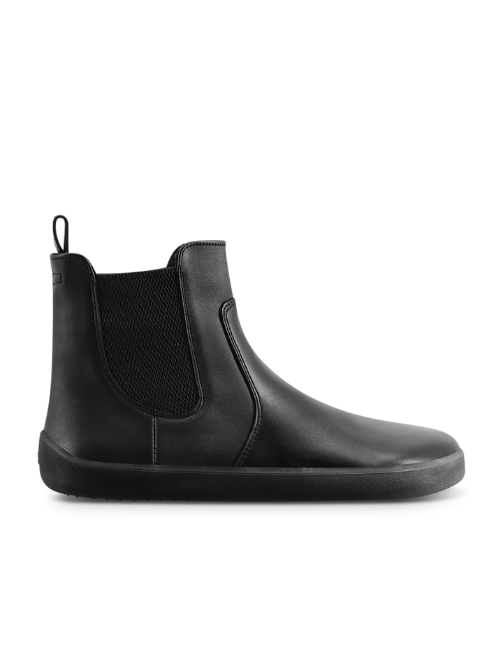 The BeLenka Entice Neo (Unisex) is a black Chelsea boot in supple napa leather with elastic side panels, a heel pull tab, and a flat rubber sole, displayed in a side profile against a white background.