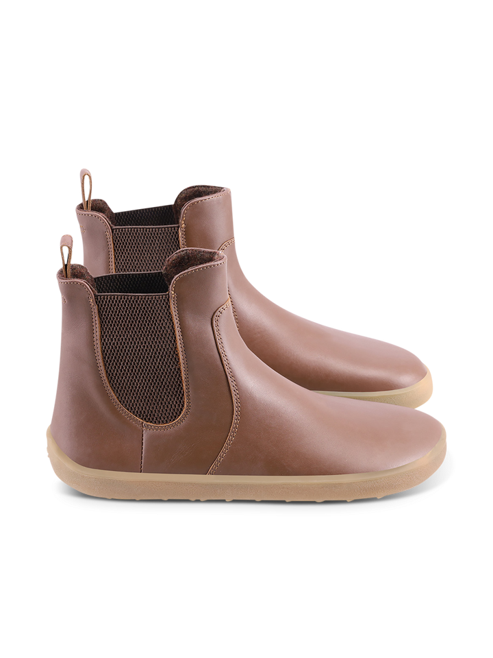 A pair of BeLenka Entice Neo (Unisex) brown Chelsea boots with a wide toe box, elastic side panels, pull tabs at the back, and light tan rubber soles, displayed on a white background.