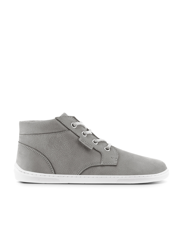 The BeLenka Synergy (Unisex) is a gray mid-top barefoot shoe with a wide toe-box, white laces, white stitching, and a white rubber sole, shown from the side on a plain white background.