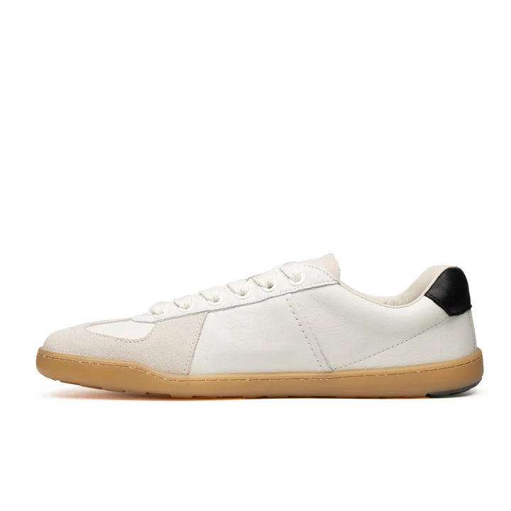 The BluSun BLSN-200 (Men’s) is a white barefoot sneaker featuring a tan sole, beige suede accents, and a black patch on the heel—handcrafted in Portugal and displayed in a left side profile against a plain white background.