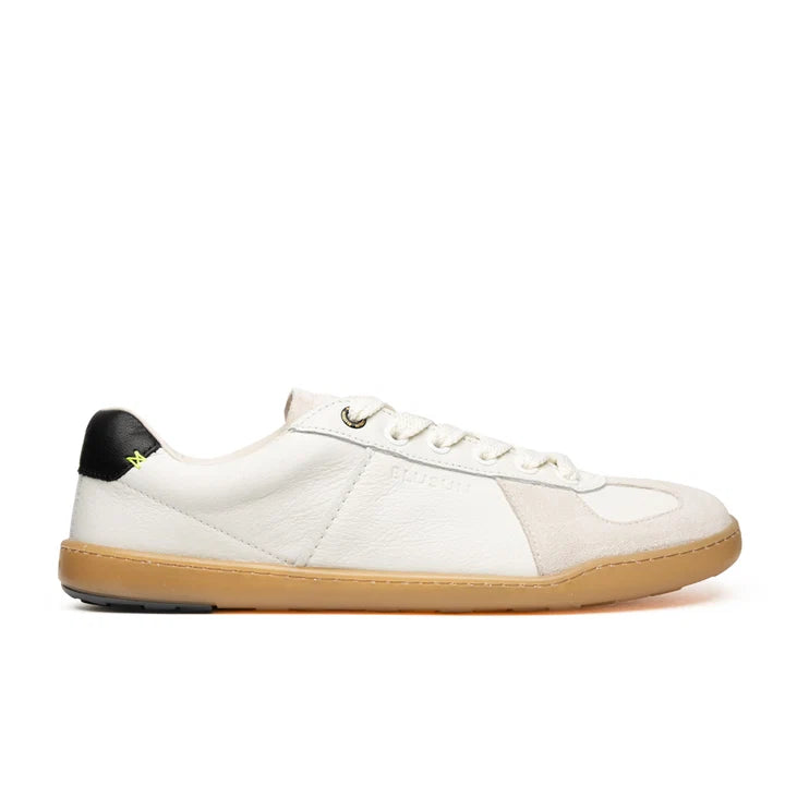 Introducing the BluSun BLSN-200 (Women’s): a handcrafted, minimalist low-top sneaker in white leather, featuring a gum sole, white laces, and a subtle black heel accent. Made in Portugal by BluSun, this barefoot-inspired shoe is showcased against a plain white background.