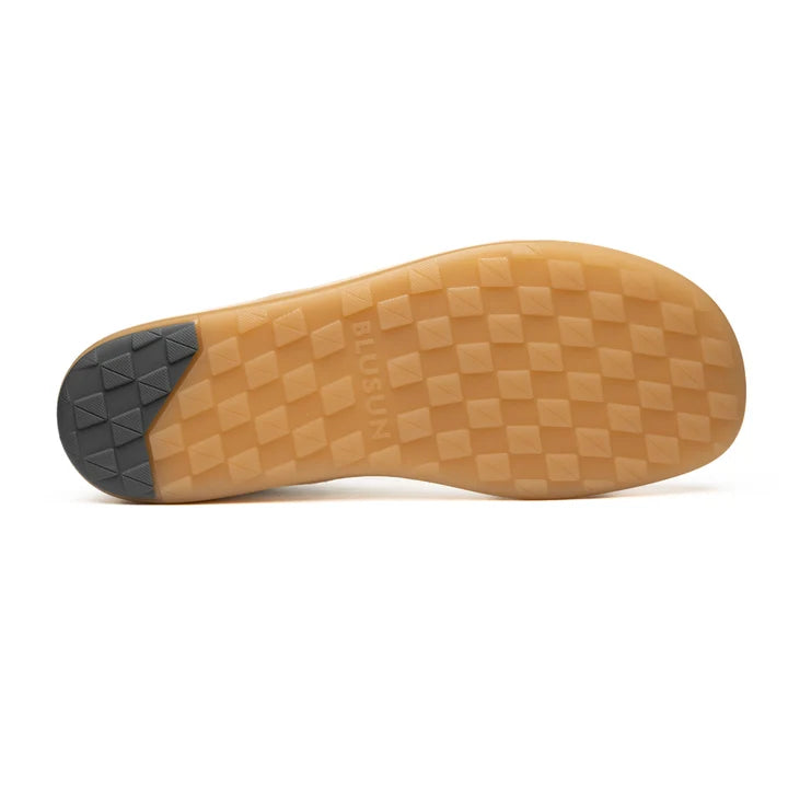 Sure! Here’s the revised sentence using your product data: The sole of the BluSun BLSN-200 men’s barefoot sneaker features a tan checkerboard tread pattern with a small black section at the heel. The subtle BLUSUN branding on the sole reflects thoughtful design and quality craftsmanship, handcrafted in Portugal.