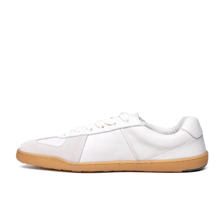 The BluSun BLSN-200 (Men’s) is a white low-top sneaker made from LWG Gold-certified leather, featuring white laces and a light brown rubber sole, displayed from the side on a white background.