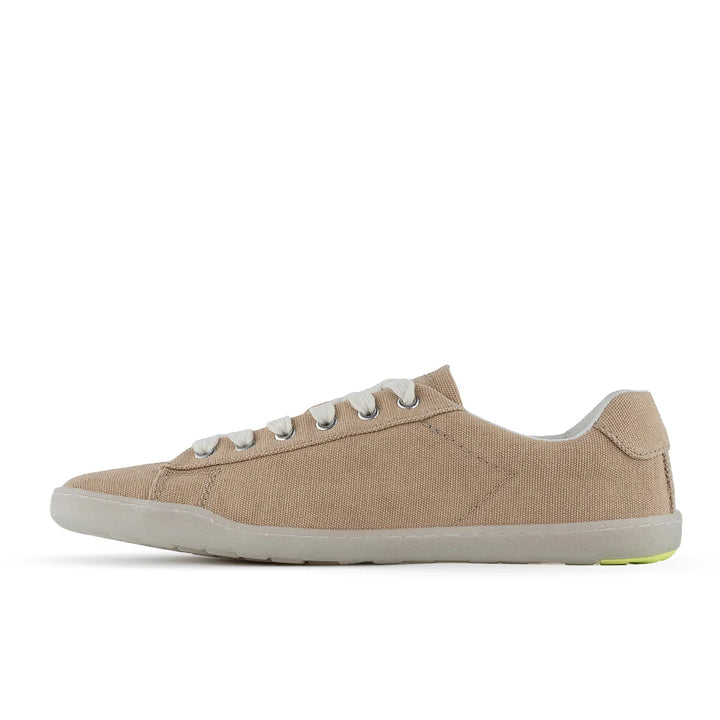 The BluSun BLSN-103 (Women’s) is a beige canvas sneaker made from organic cotton, featuring white laces and a light gray rubber sole for barefoot comfort, displayed in a left-side profile against a white background.