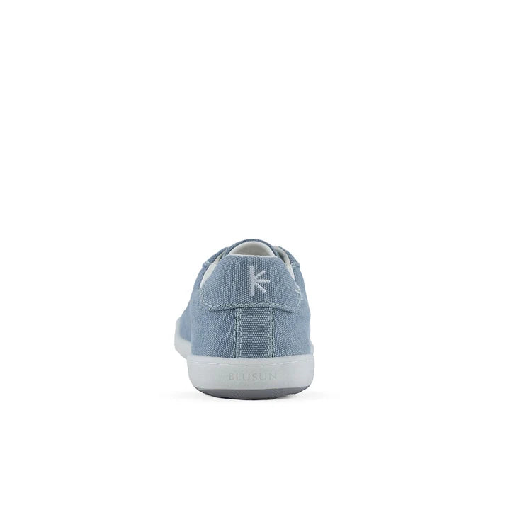 A rear view of the BluSun BLSN-103 men’s sneaker in light blue highlights its white sole, small fabric heel loop, and subtle logo on the heel tab. Designed as a sustainable sneaker, it’s an ideal choice for eco-conscious style. The product is photographed against a plain white background.