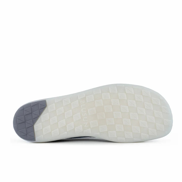 Certainly! Here’s the revised sentence using your product data: The sole of the BluSun BLSN-103 (Men’s) shoe features a diamond-patterned tread, mostly white with a dark gray section at the heel, and the word BLUSUN embossed in the center—perfectly encapsulating the minimalist comfort of barefoot shoes.