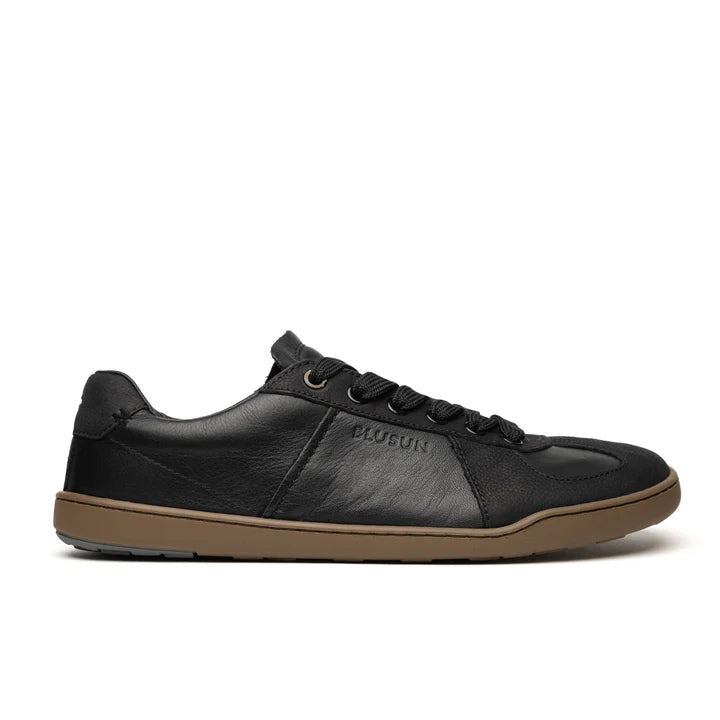 Introducing the BLSN-200 (Men’s) by BluSun—a black leather barefoot sneaker featuring black laces, a sleek low-profile silhouette, and a durable brown rubber sole. The side of the shoe is embossed with “PLUGUN” for a distinctive touch. An organic cotton lining enhances comfort and breathability.