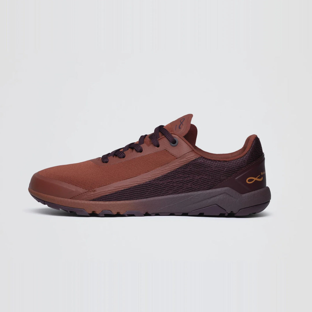 The Notace Yama T1 (Women’s) trail shoe, shown on a plain white background, features a brown and dark maroon mesh upper, a rubber sole designed for enhanced traction, and a gold Notace logo on the heel.