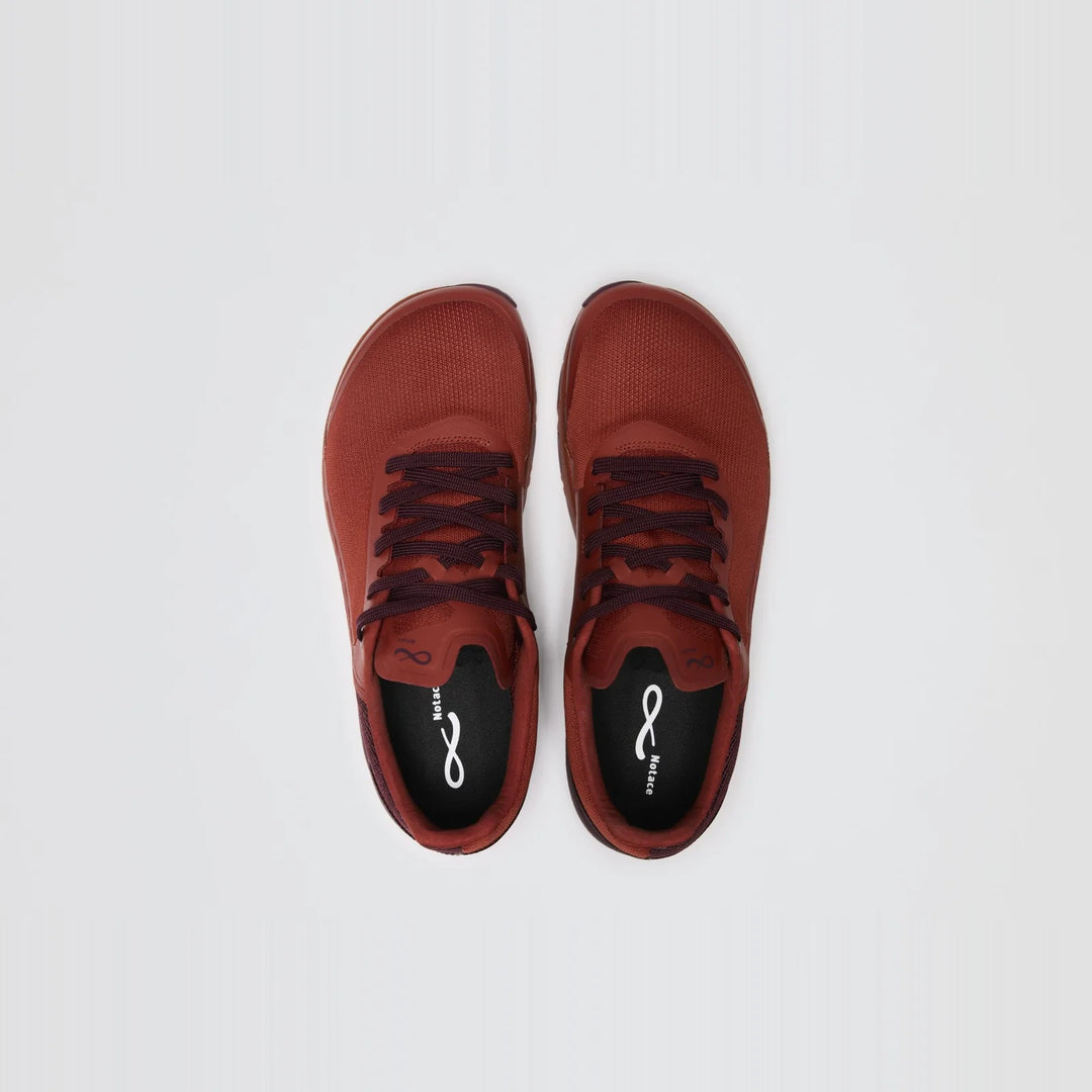 A pair of Notace Yama T1 (Men’s) red trail sneakers, featuring black insoles and laces, is displayed from above on a plain white background. Designed for all-day comfort, these shoes seamlessly blend style and performance.