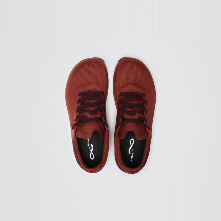 A pair of Notace Yama T1 (Men’s) red trail sneakers, featuring black insoles and laces, is displayed from above on a plain white background. Designed for all-day comfort, these shoes seamlessly blend style and performance.
