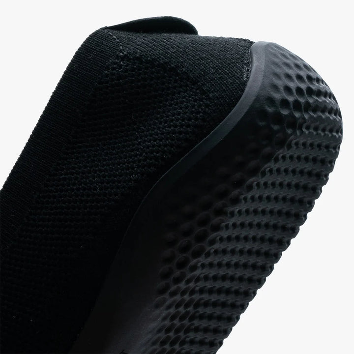 Close-up of the VIVOBAREFOOT Asana Yin Ballerina Knit (Women's) showing its black mesh upper and textured, dimpled sole for grip.