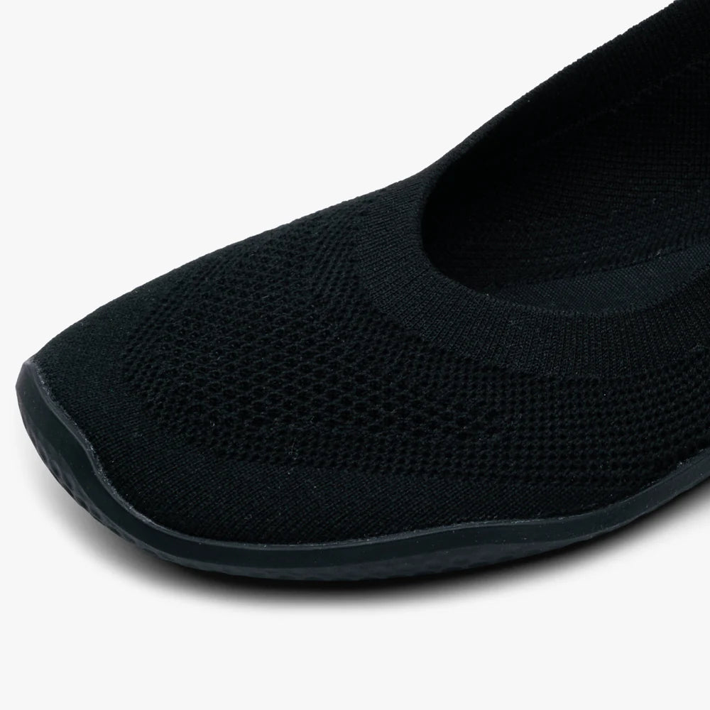 Close-up of the toe and front side of the VIVOBAREFOOT Asana Yin Ballerina Knit (Women's), featuring a black textured, breathable knit fabric with a slightly raised edge on the sole.