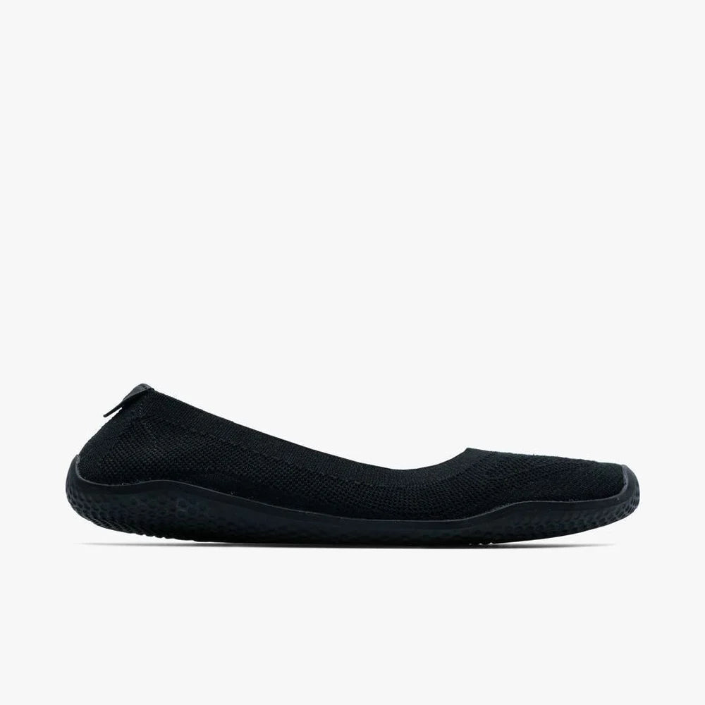 The VIVOBAREFOOT Asana Yin Ballerina Knit (Women's) is a black slip-on ballet flat with a knit upper, textured rubber sole, and heel pull tab, shown in side profile on a plain white background.